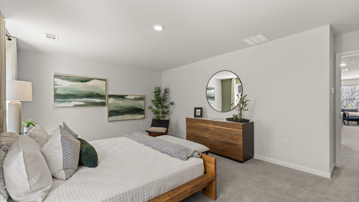 Interior primary bedroom with windows and accent wall