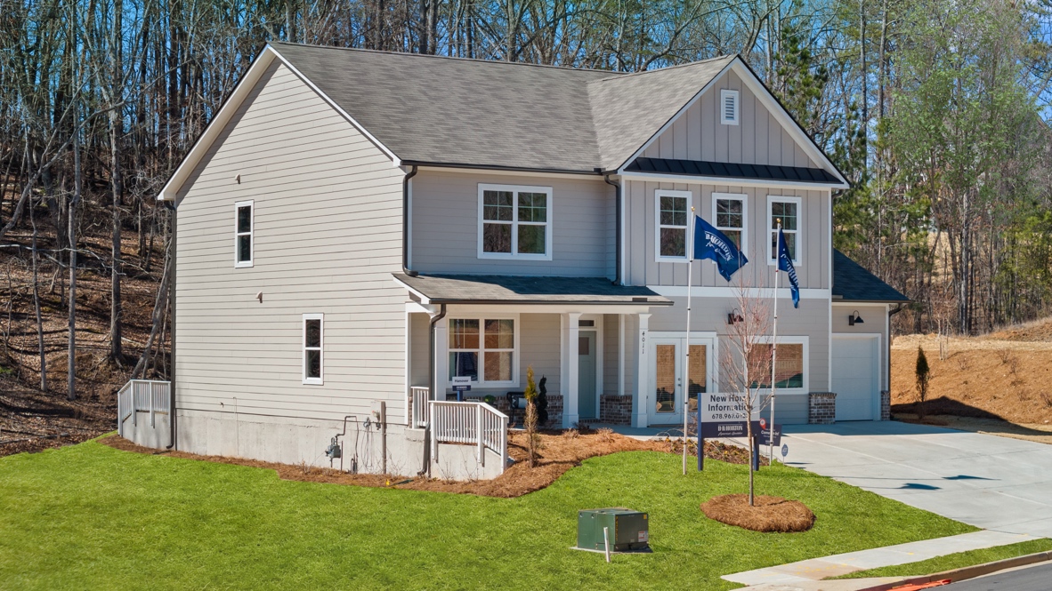 Exterior two-story home with cladding and stone detailing