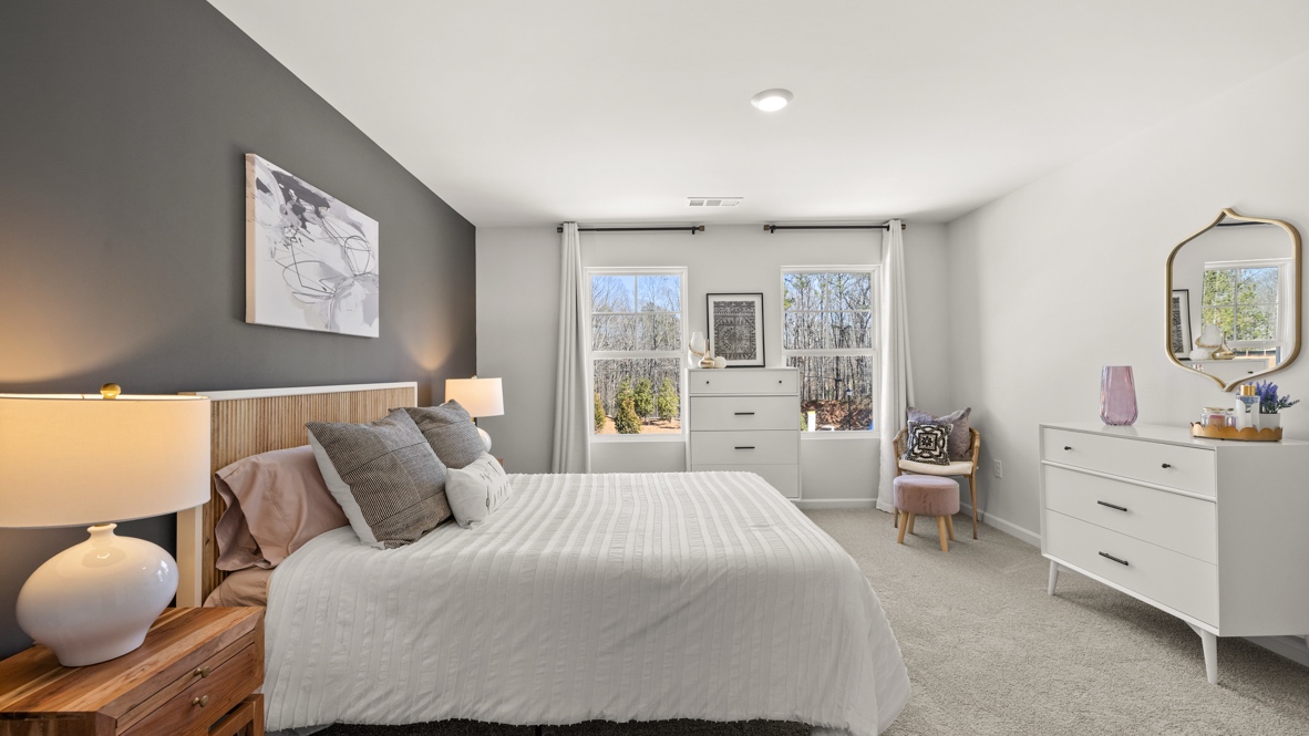 Interior bedroom with large windows and accent wall