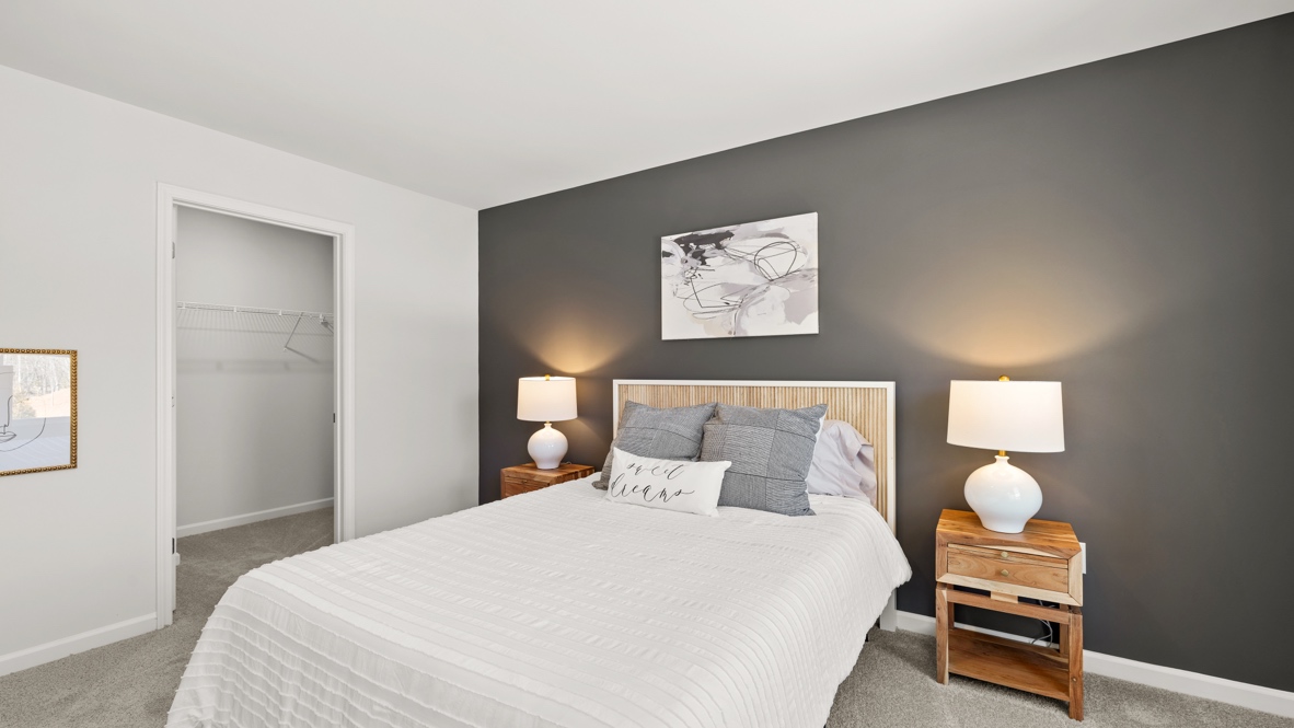 Interior bedroom with large windows and accent wall