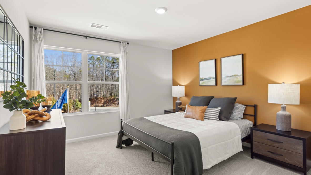 Interior bedroom with large window and accent wall