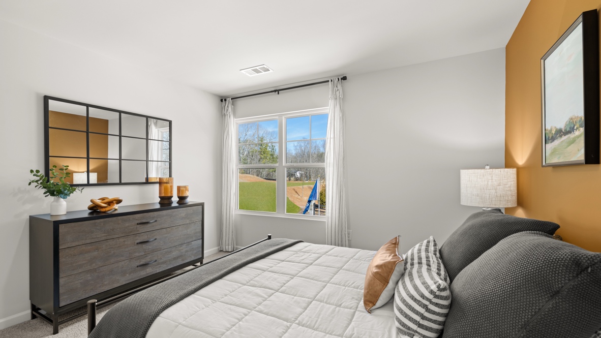 Interior bedroom with large window and accent wall