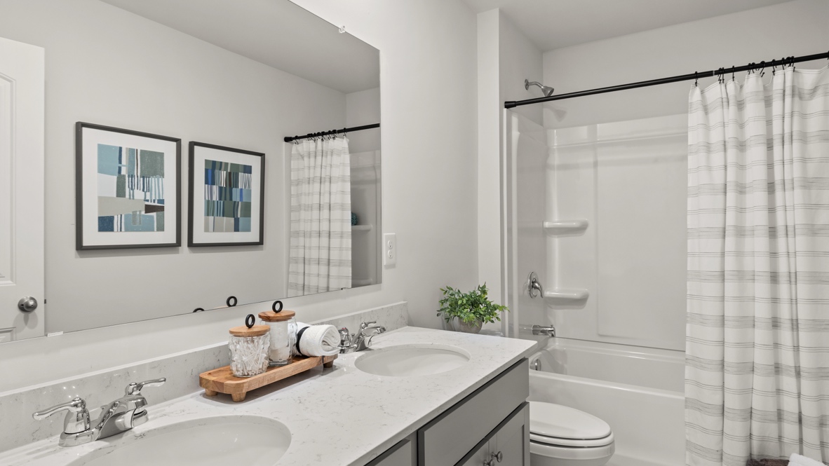 Interior bathroom with double sink and full-sized shower