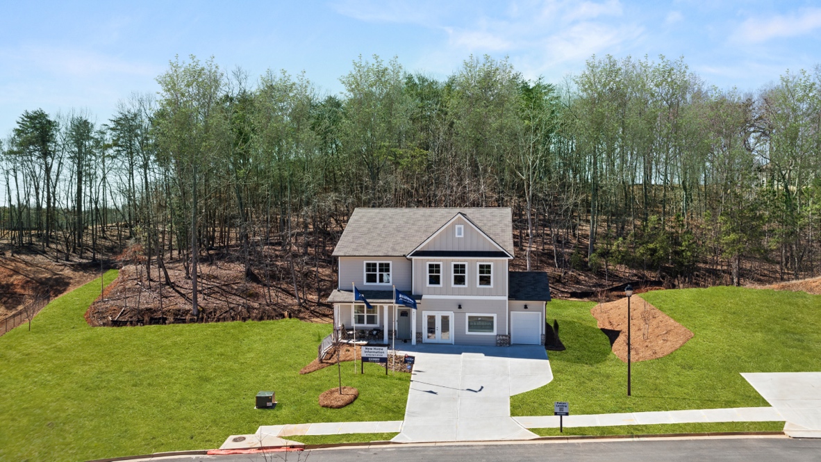 Exterior two-story home with cladding and stone detailing