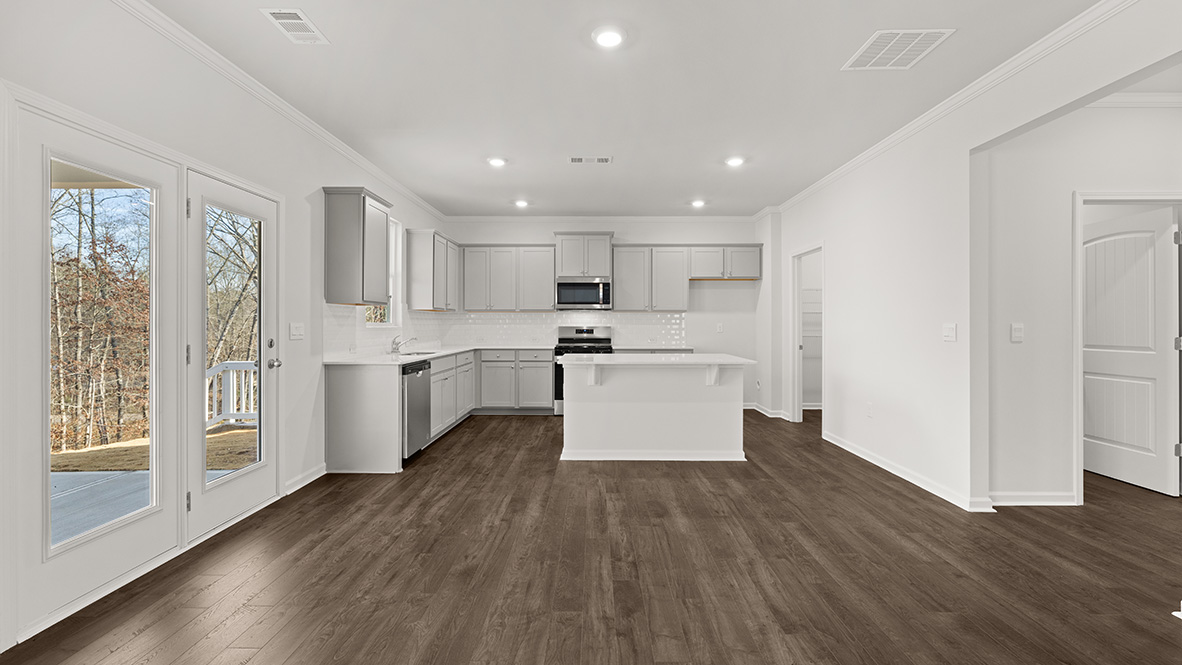 kitchen with light grey cabinetry, large island and stainless steel appliances