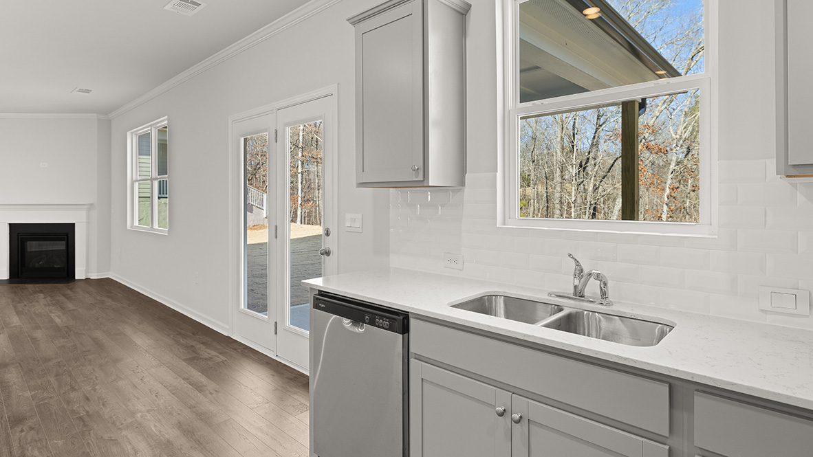 kitchen with light grey cabinetry, large island and stainless steel appliances