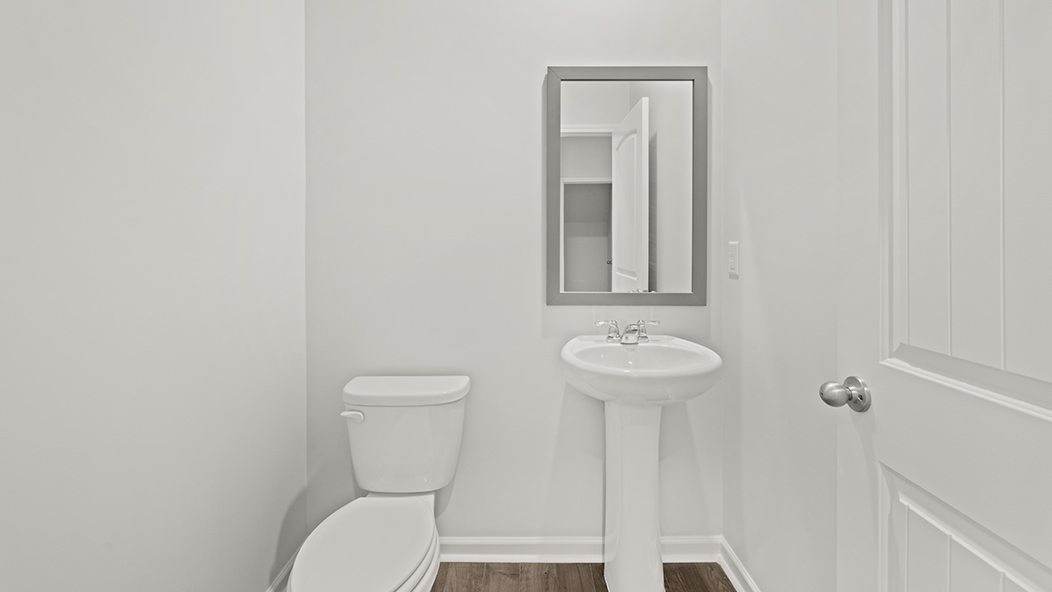 Powder bathroom with a pedestal sink and mirror