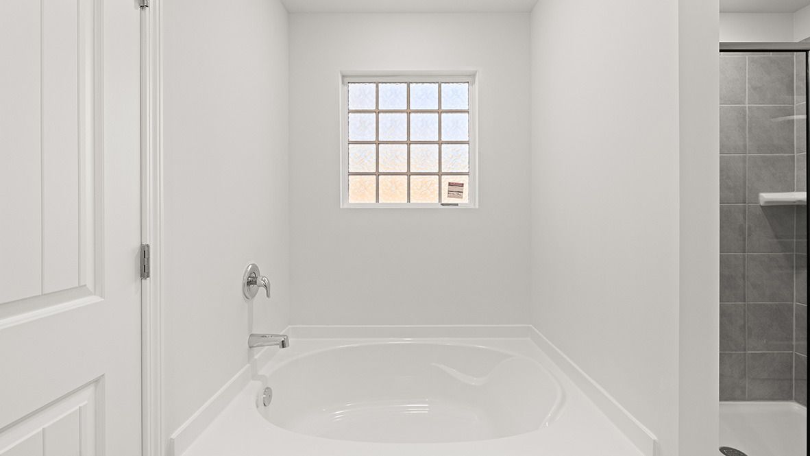 bathroom with dual vanity sinks, toilet, bath tub and a walk in shower