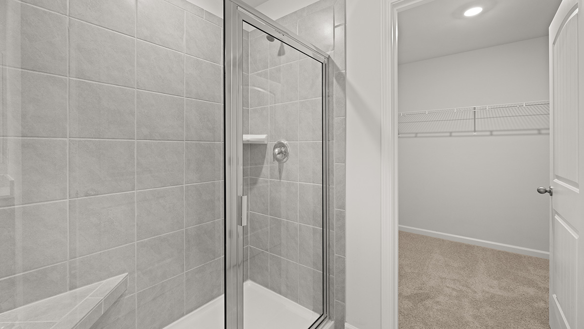 bathroom with dual vanity sinks, toilet, bath tub and a walk in shower