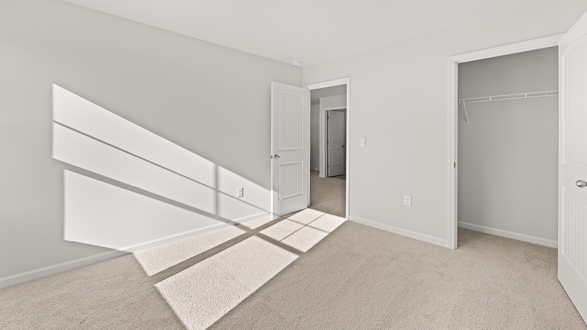 View of bedroom overlooking the closet and hallway doors