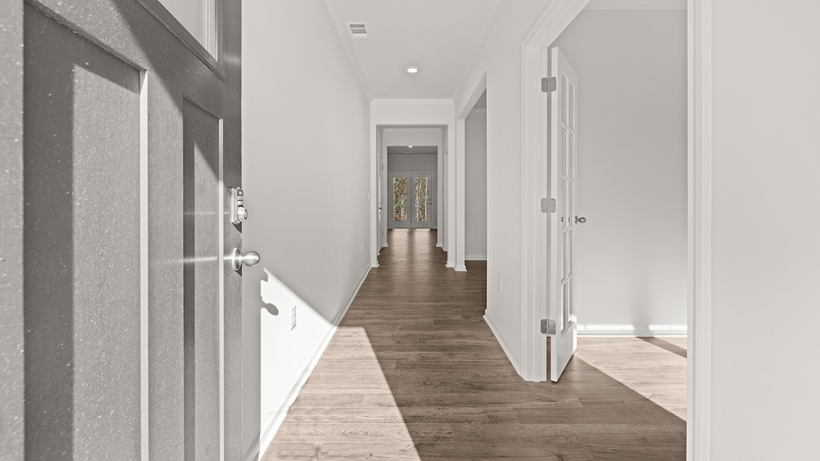 front entry way of home featuring brown flooring and white walls