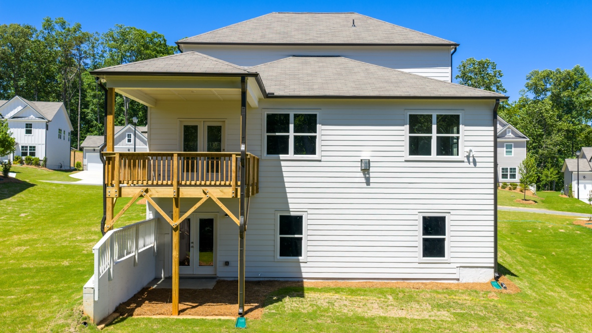 rear exterior of home featuring the covered patio deck on the second story