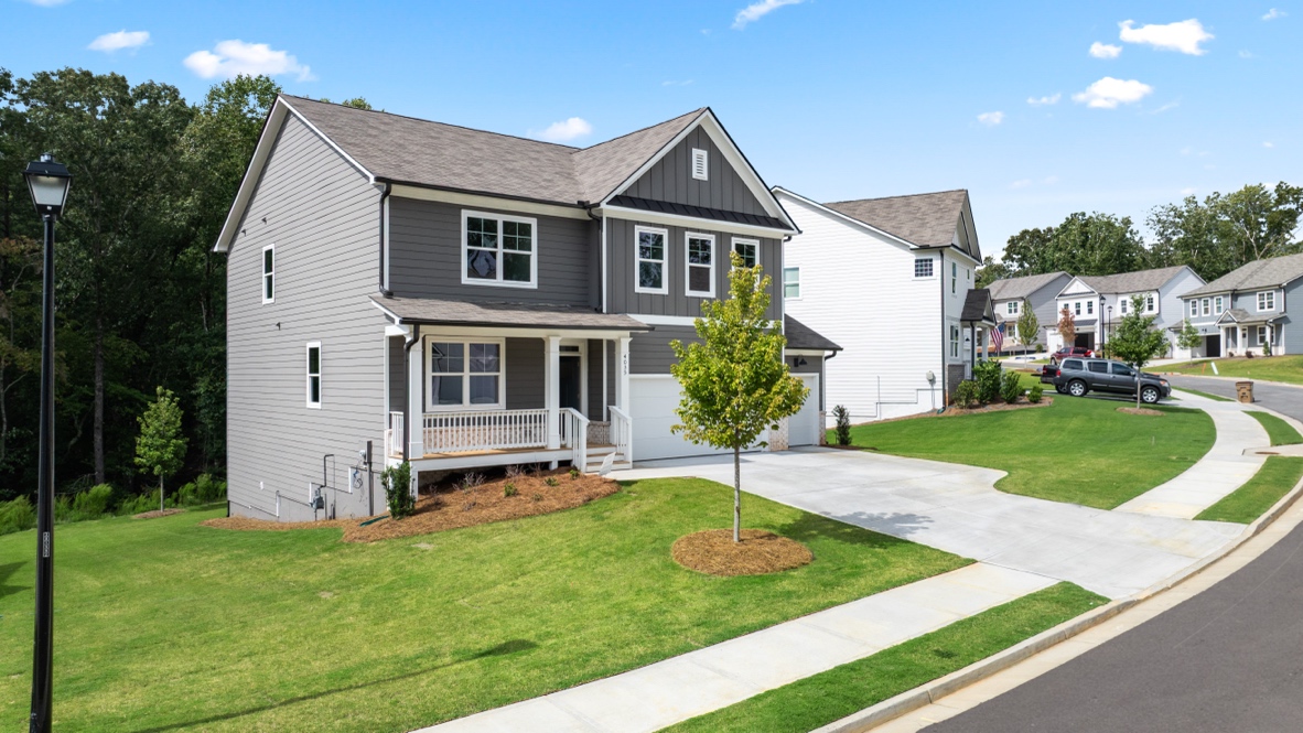 Exterior two-story grey home with stone detailing