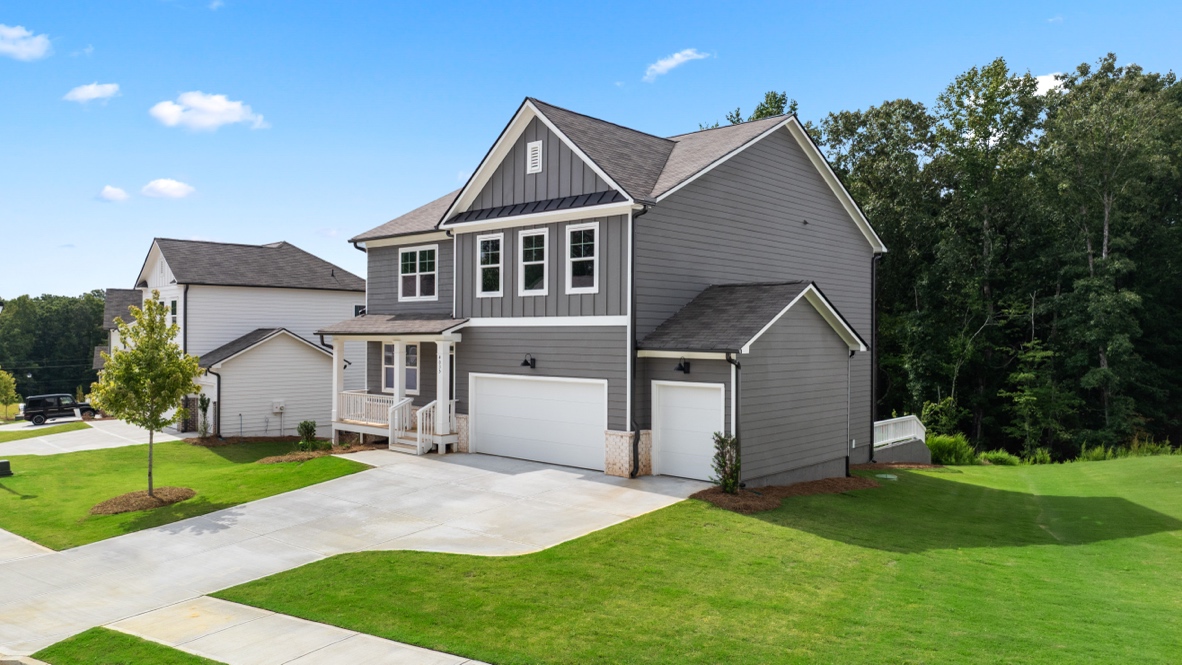 Exterior two-story grey home with stone detailing