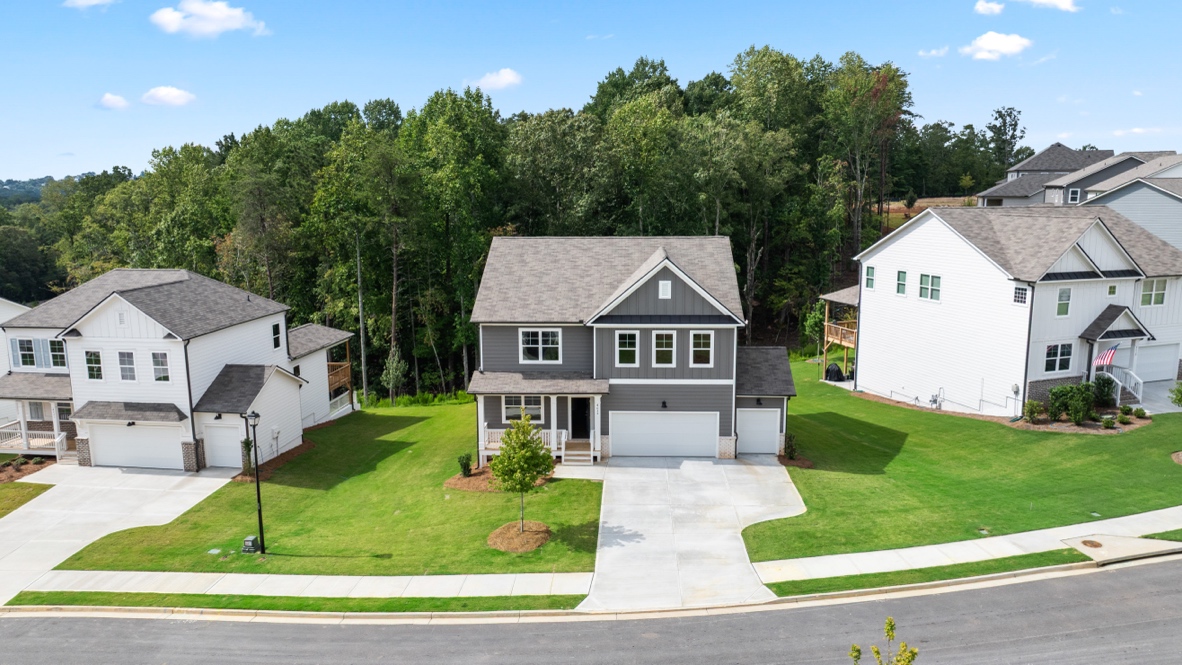 Exterior two-story grey home with stone detailing