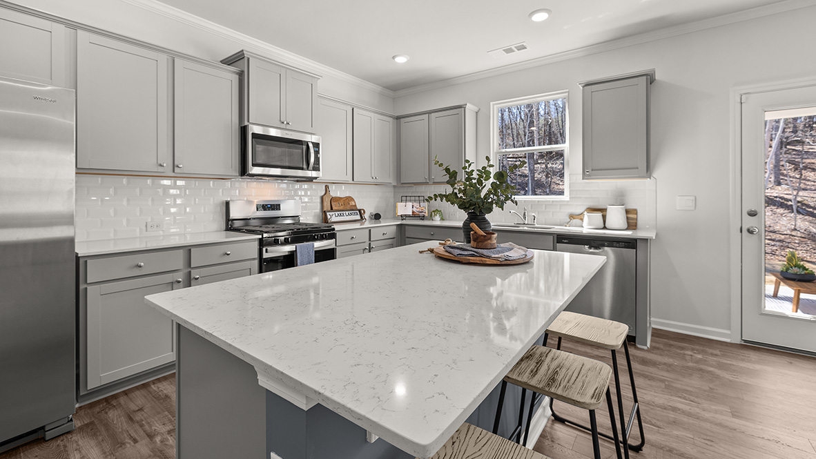Interior kitchen with center island and light grey cabinets