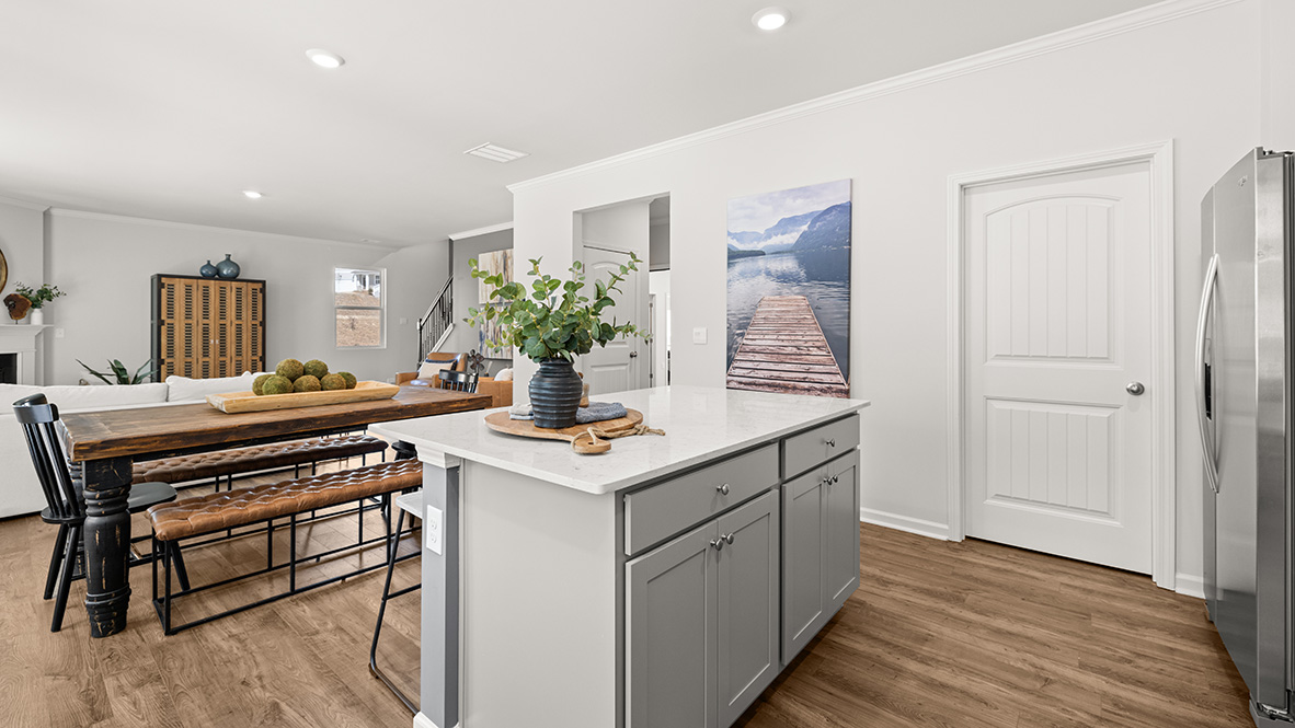 Interior kitchen with center island and light grey cabinets