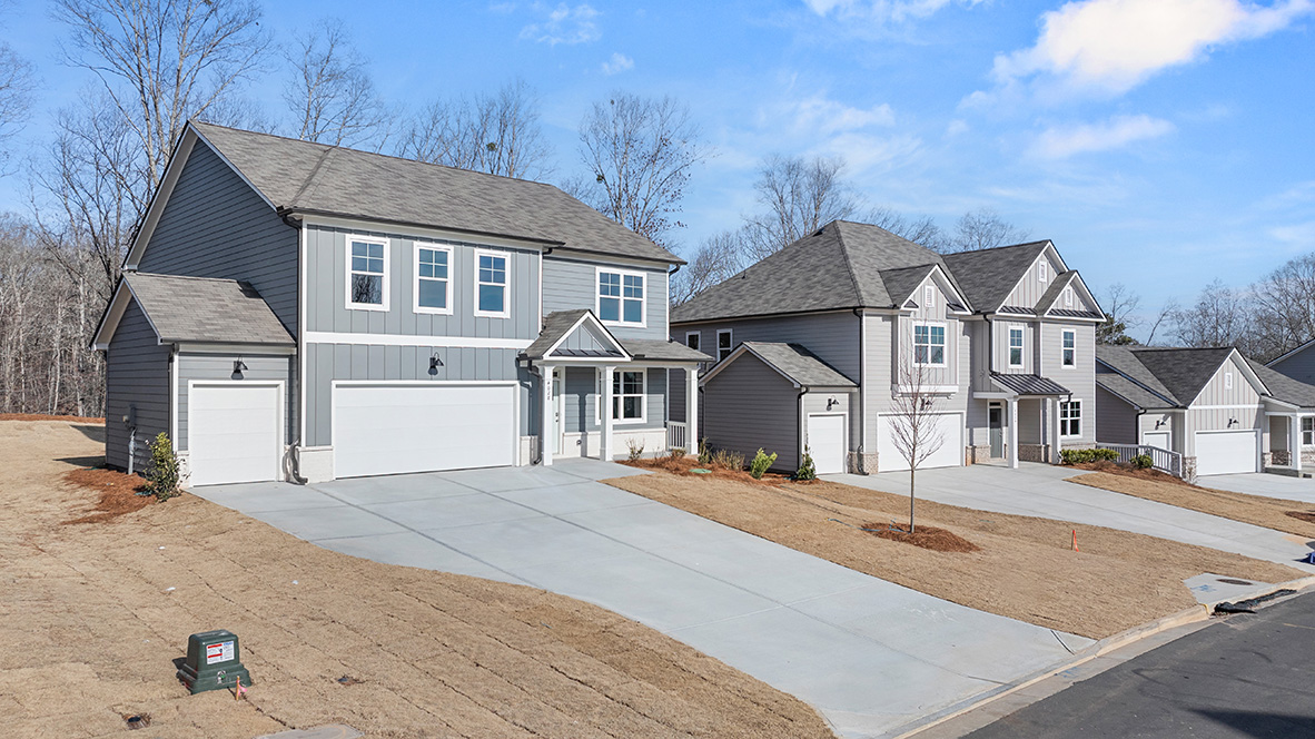 Exterior light blue two-story home with stone detailing