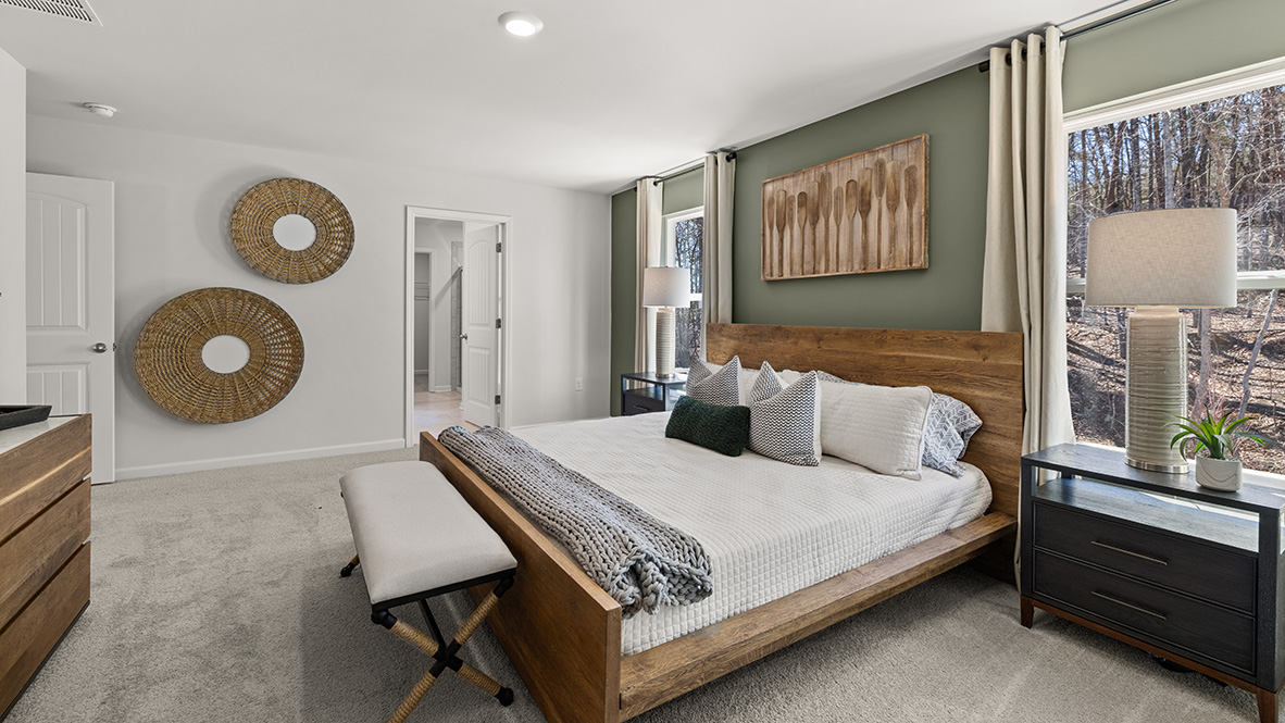 Interior primary bedroom with windows