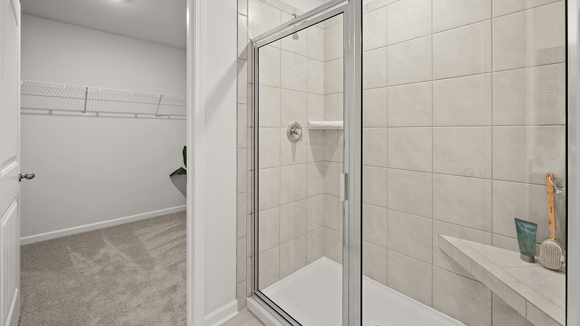 Interior primary bathroom with bath tub and window