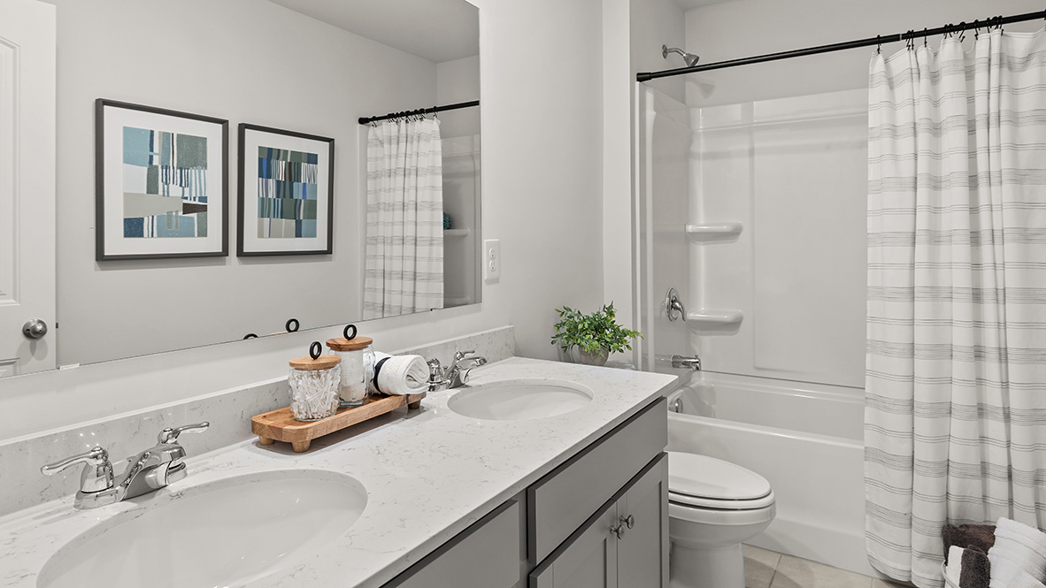 Interior bathroom with double sink and full-sized shower