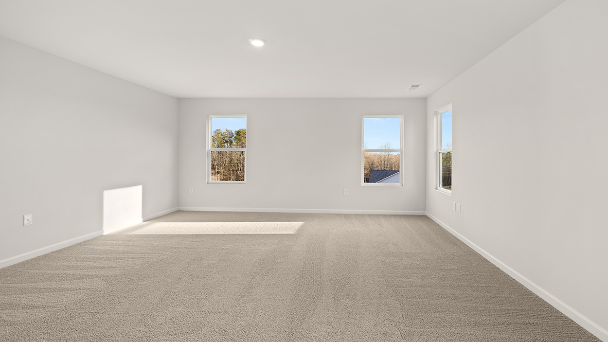 bedroom with beige carpet, white walls and two windows