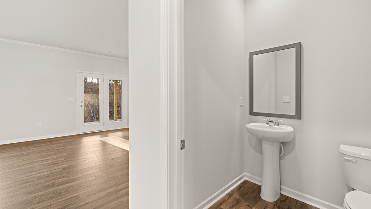 Powder bathroom with a pedestal sink and mirror