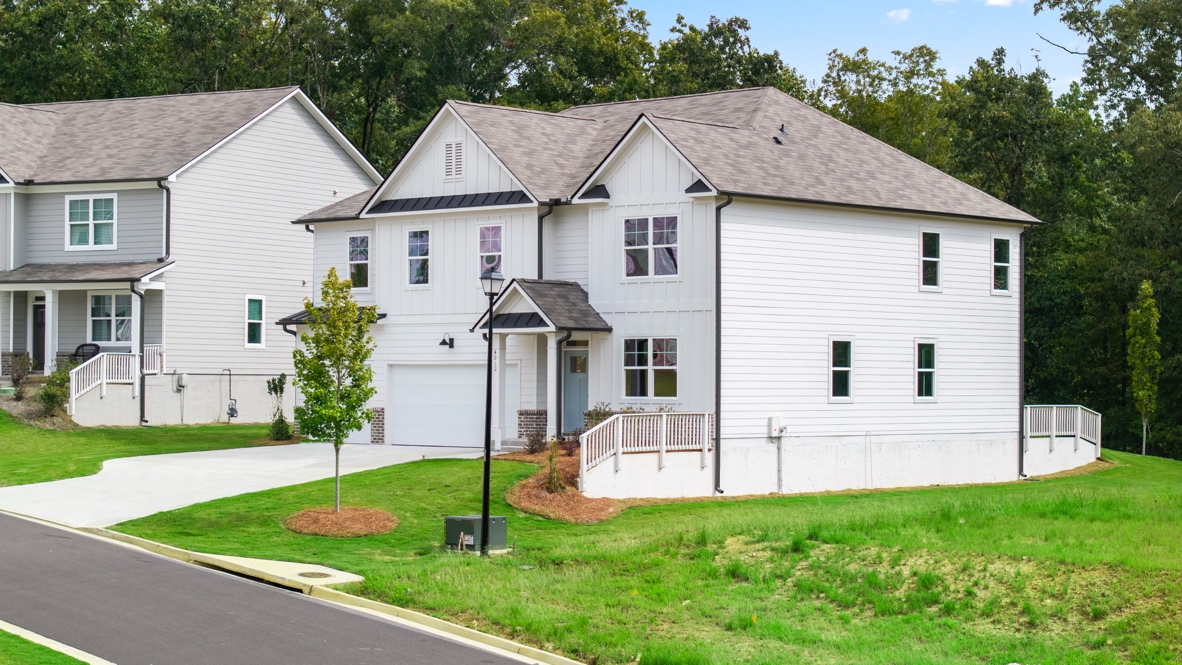 Exterior two-story white homes with stone detailing