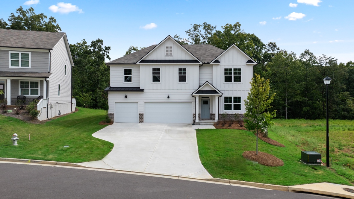 Exterior two-story white home with stone detailing