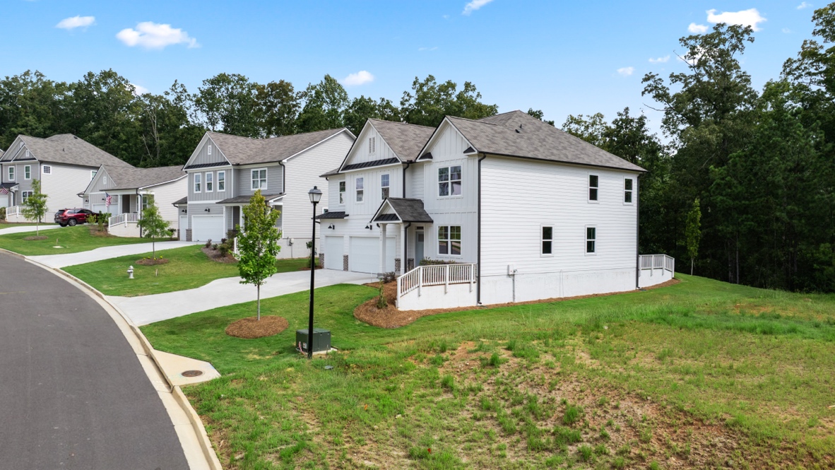Exterior two-story white homes with stone detailing