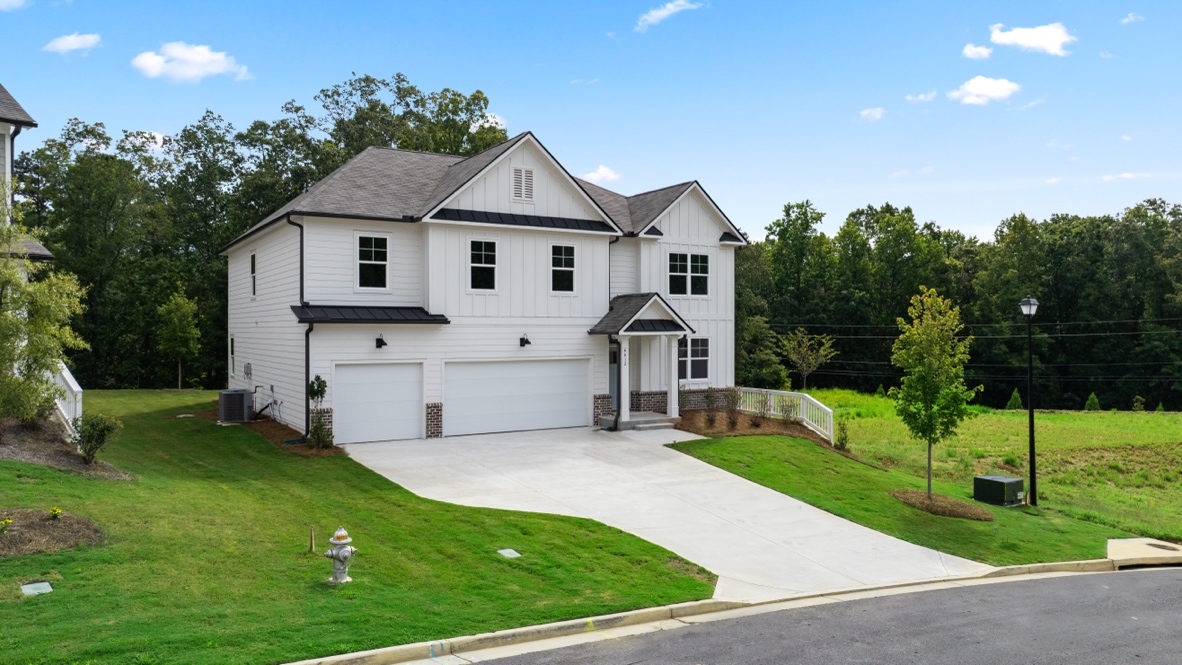 Exterior two-story white home with stone detailing