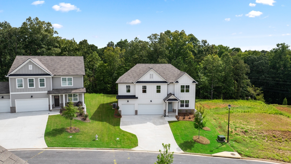 Exterior two-story white homes with stone detailing