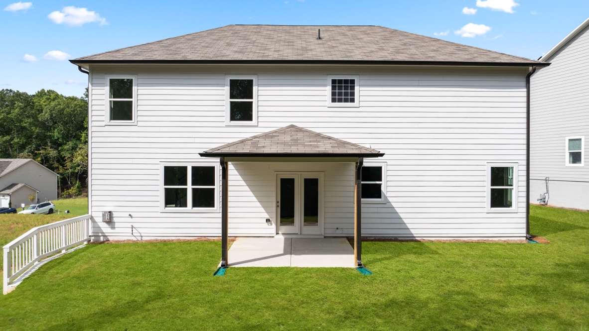 rear exterior of home featuring a covered concrete patio