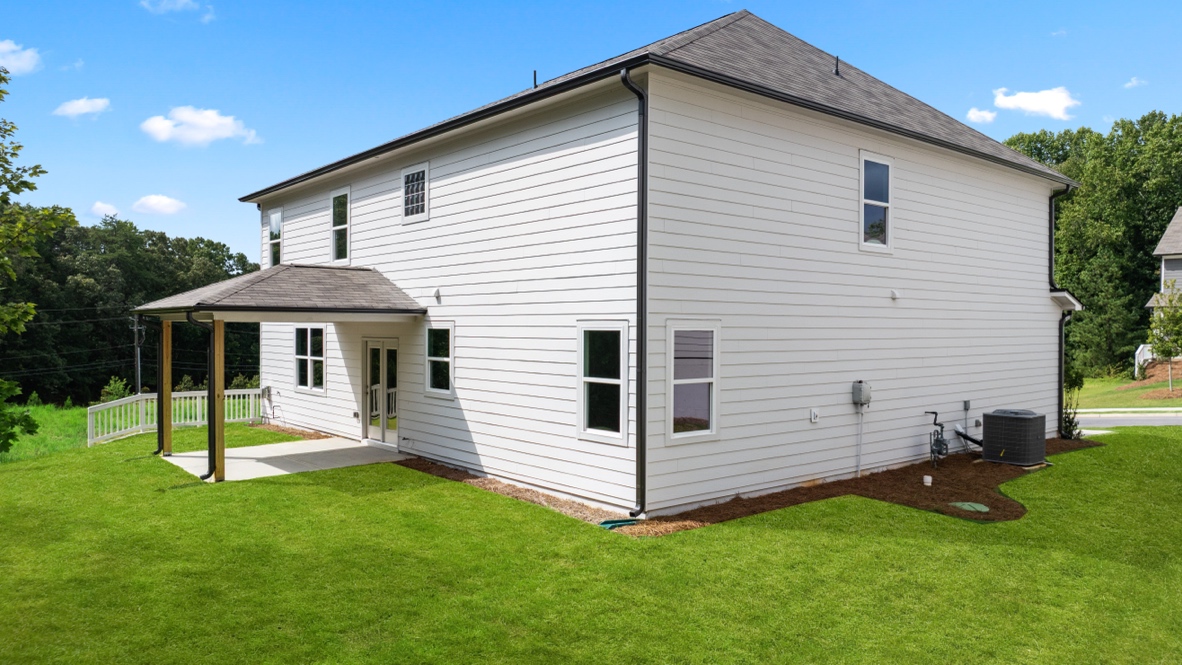 rear exterior of home featuring a covered concrete patio