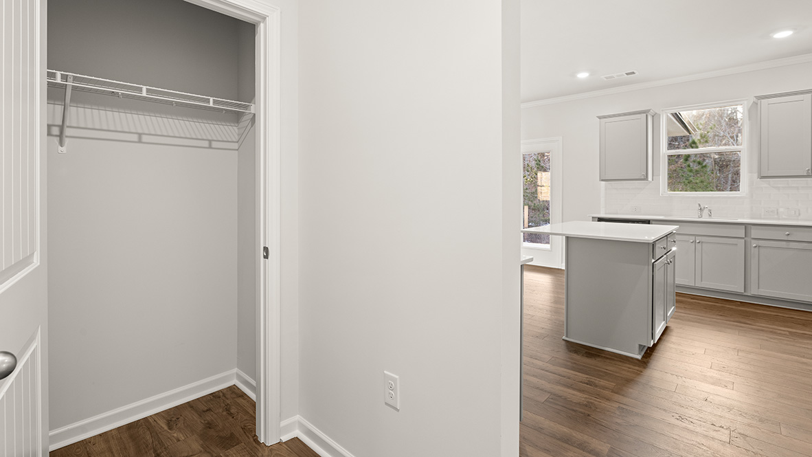Pantry with wire shelving and kitchen island
