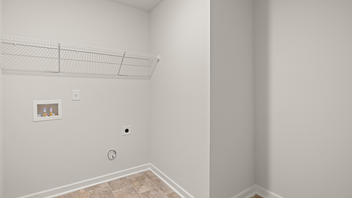 Laundry room with shelf, tile floors, and washer and dryer connections.