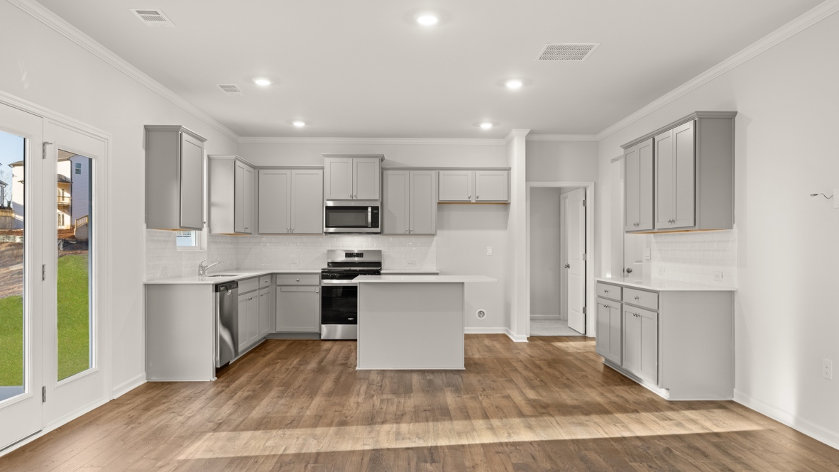 Interior kitchen with center island and light grey cabinets