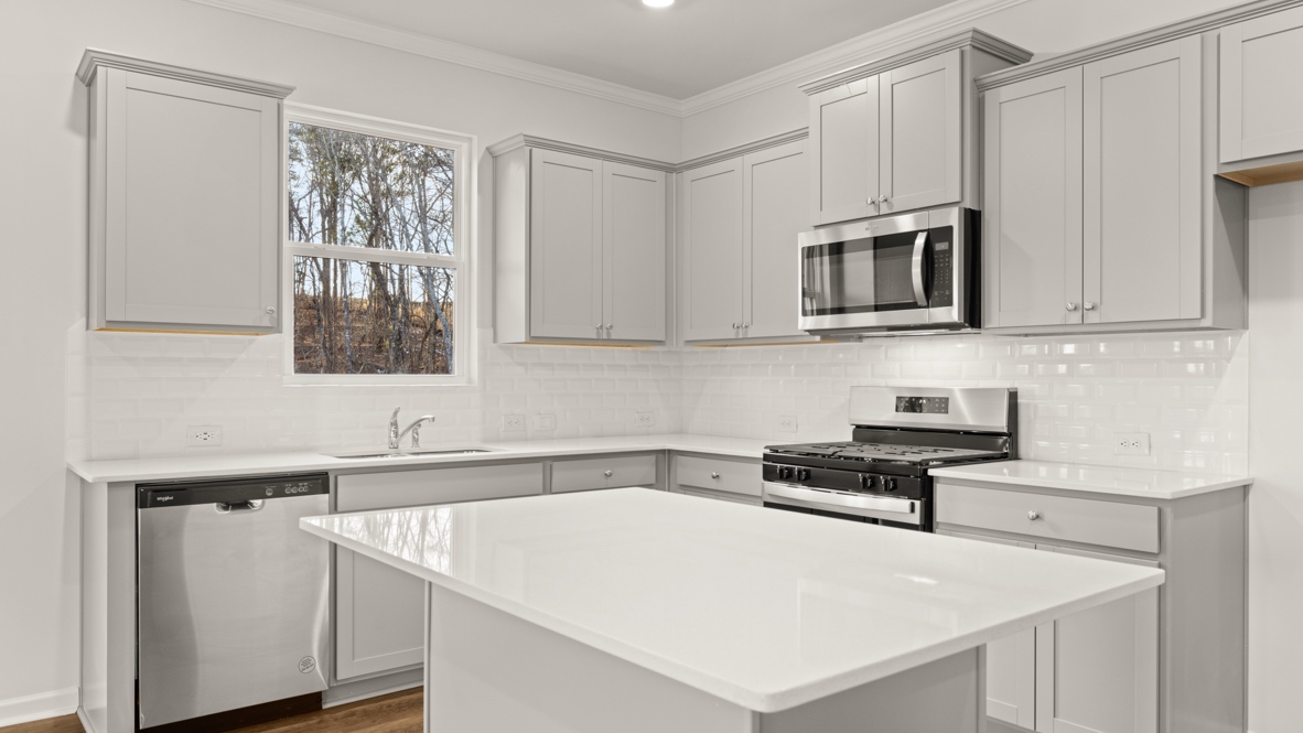 Interior kitchen with center island and light grey cabinets