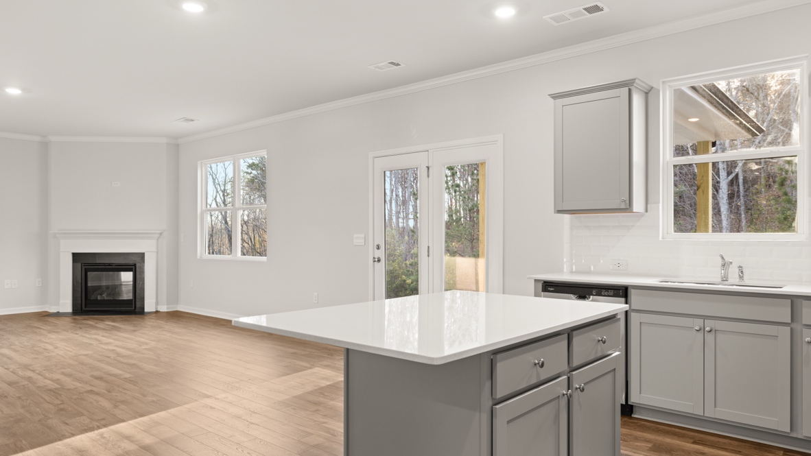 Interior kitchen with center island and light grey cabinets