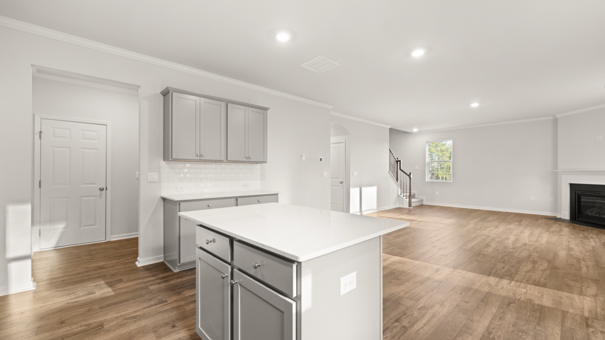 Interior kitchen with center island and light grey cabinets