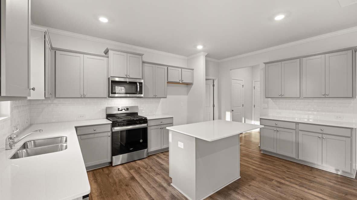 Interior kitchen with center island and light grey cabinets