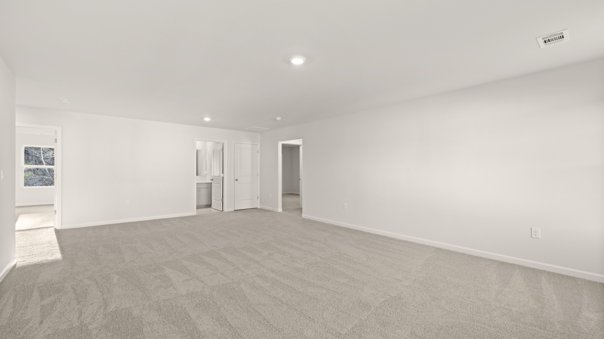 Interior primary bedroom with windows