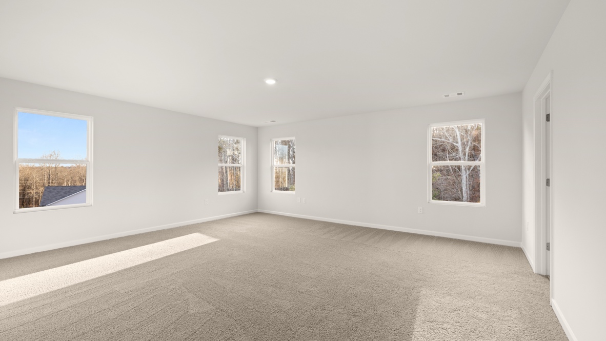 Interior primary bedroom with windows