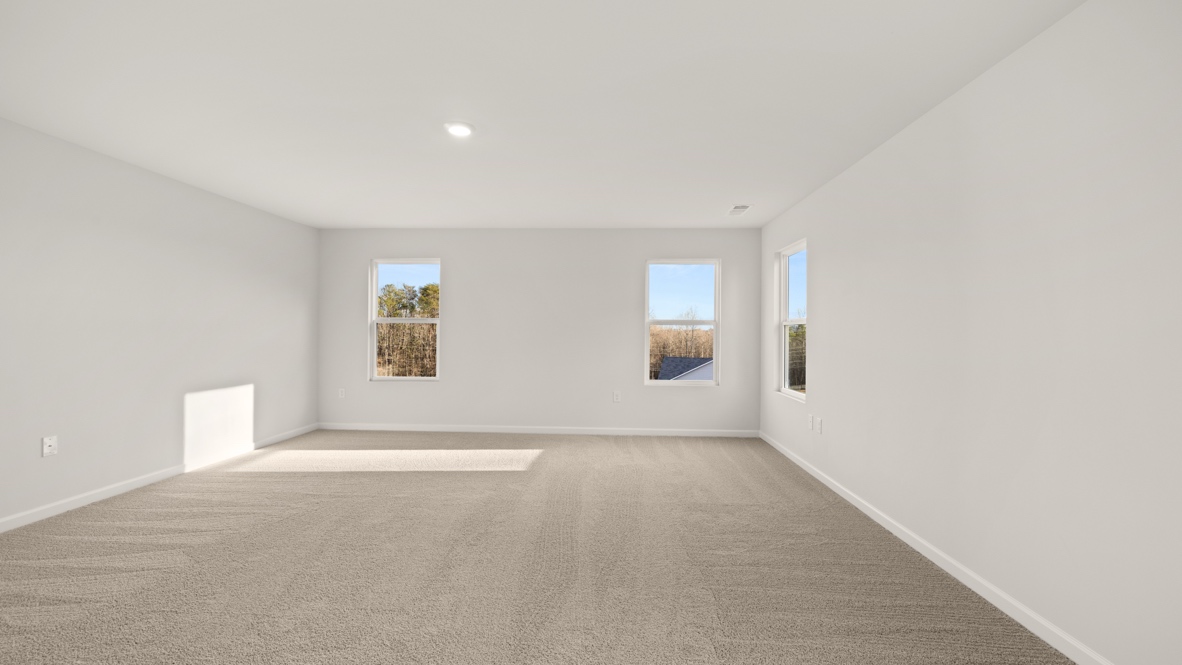 Interior primary bedroom with windows
