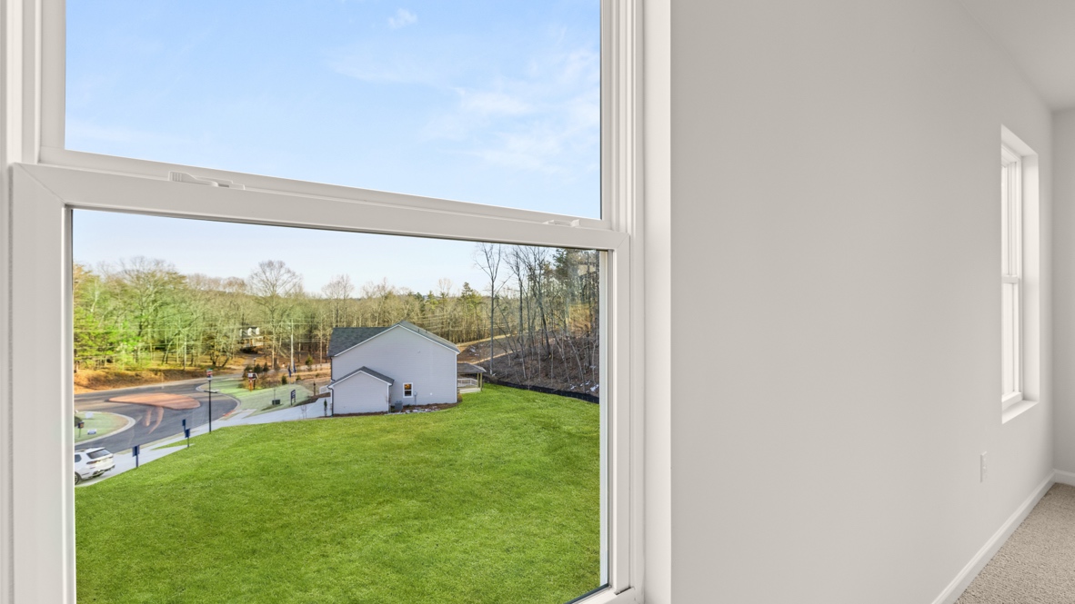 Interior primary bedroom with windows