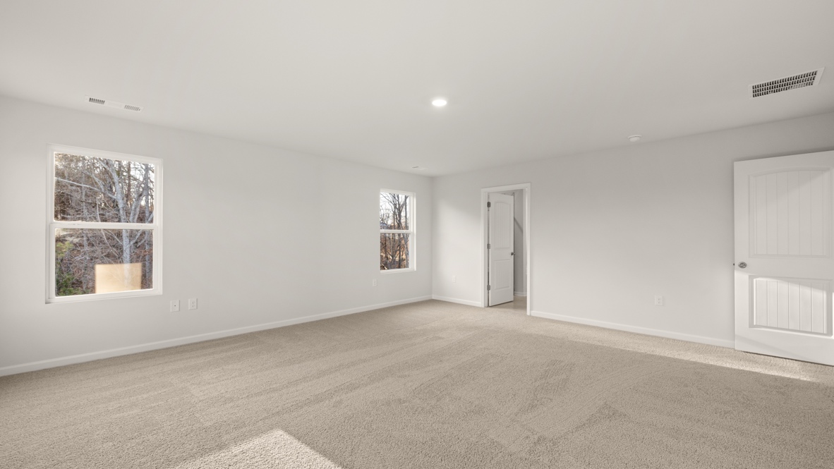 Interior primary bedroom with windows