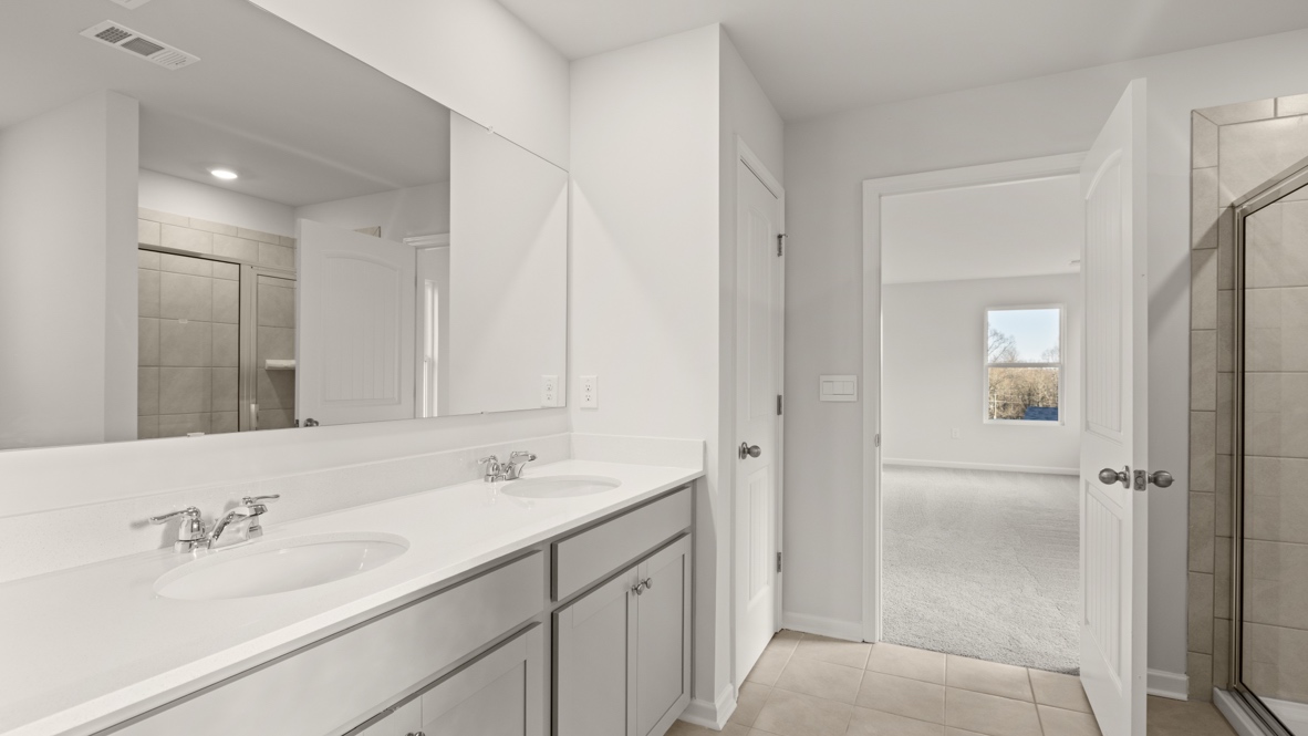 Interior primary bathroom with double sink and shower