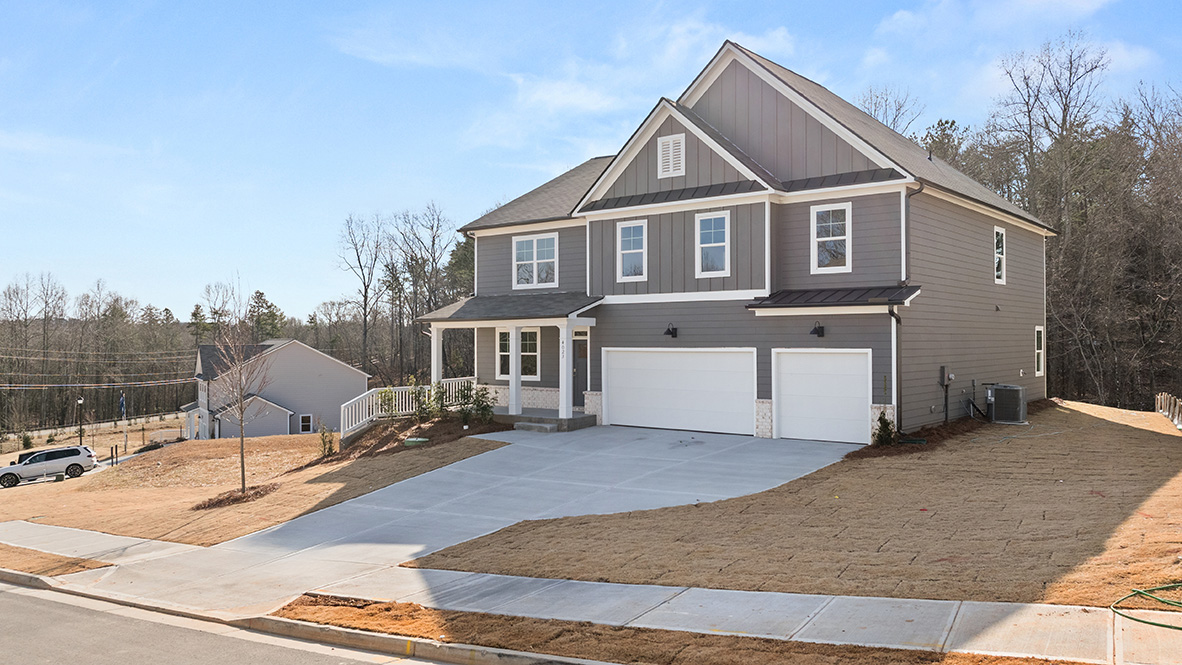 Exterior grey two-story home with stone detailn