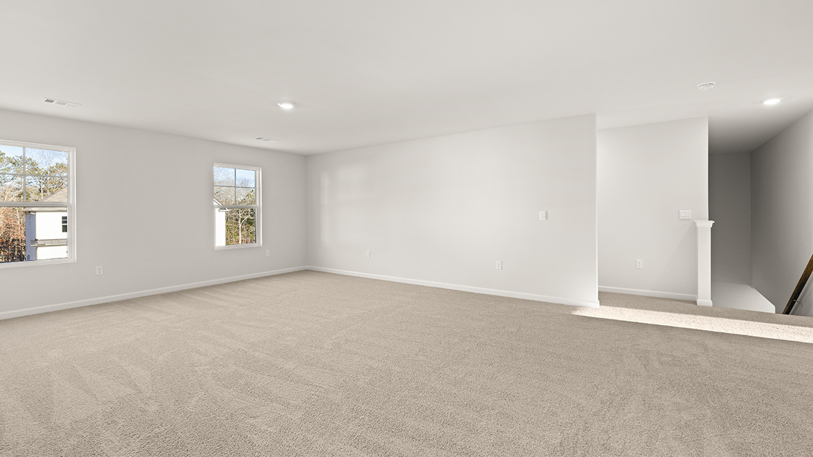 Interior upstairs loft area with large windows