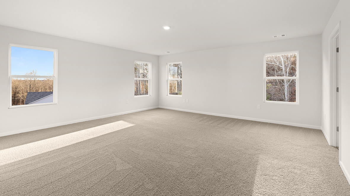 Interior primary bedroom with windows